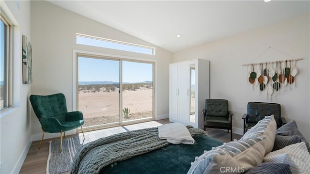 bedroom with access to outside, baseboards, lofted ceiling, and light wood finished floors