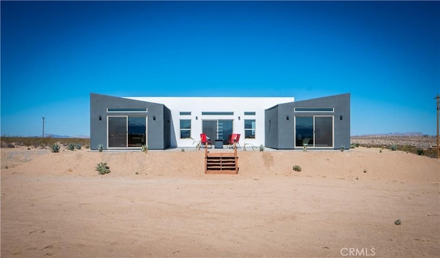 back of property with stucco siding