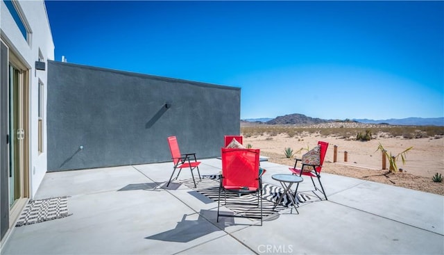 view of patio / terrace featuring a mountain view