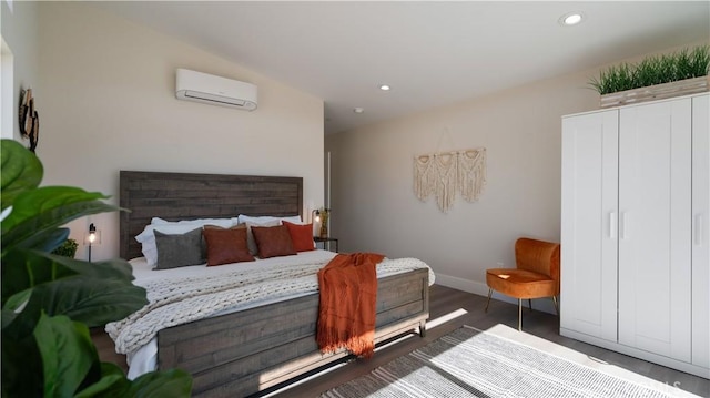 bedroom featuring dark wood-type flooring, recessed lighting, an AC wall unit, and baseboards