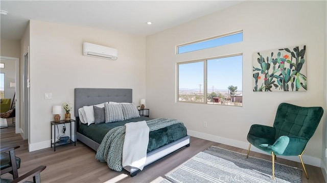 bedroom with dark wood-style floors, an AC wall unit, recessed lighting, and baseboards