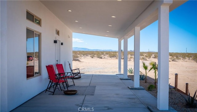 view of patio / terrace featuring a mountain view