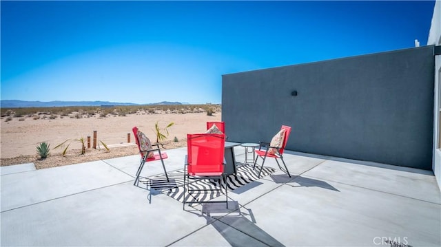 view of patio / terrace with a mountain view