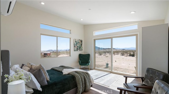 bedroom featuring access to outside, multiple windows, a mountain view, and an AC wall unit