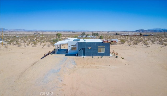 birds eye view of property featuring a mountain view