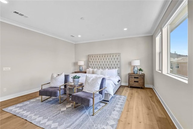 bedroom featuring light wood-type flooring, visible vents, and crown molding