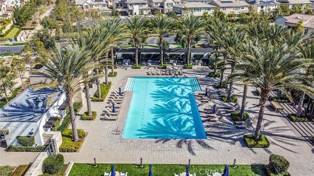 community pool featuring a residential view and a patio