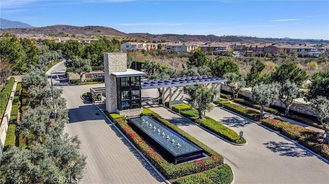 drone / aerial view featuring a residential view and a mountain view