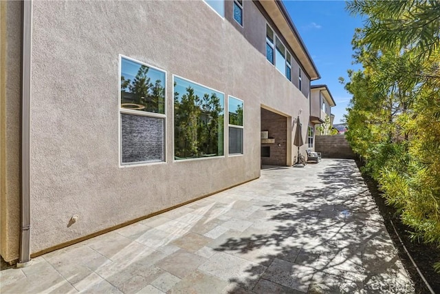 58 Sagan Way, Irvine, CA 92618 - view of property exterior featuring a patio, stucco siding, and fence