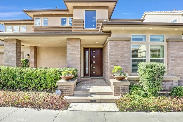 entrance to property featuring stucco siding