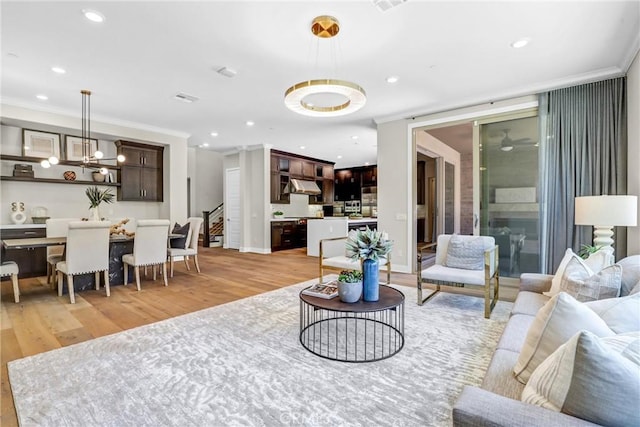 58 Sagan Way, Irvine, CA 92618 - living room featuring light wood-style flooring, ornamental molding, stairway, recessed lighting, and baseboards