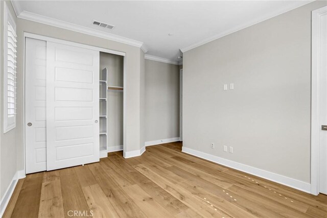 58 Sagan Way, Irvine, CA 92618 - unfurnished bedroom with baseboards, light wood-style floors, ornamental molding, and a closet