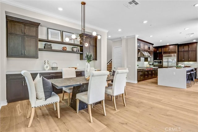 58 Sagan Way, Irvine, CA 92618 - dining area with ornamental molding, light wood finished floors, recessed lighting, stairs, and baseboards