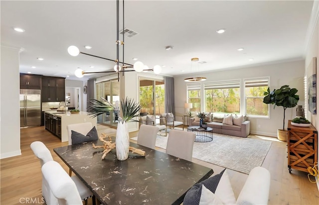 58 Sagan Way, Irvine, CA 92618 - dining space featuring light wood finished floors, recessed lighting, crown molding, and baseboards