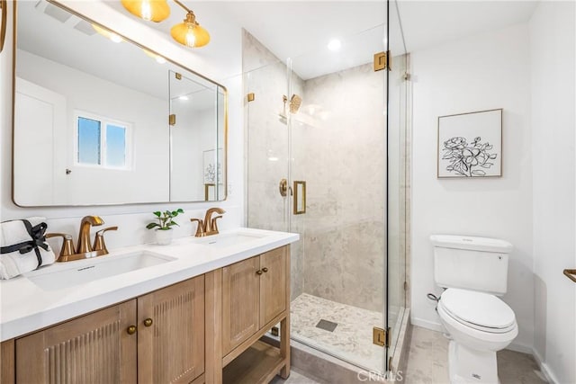 full bath featuring a sink, toilet, a stall shower, and double vanity