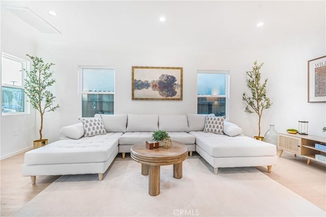 living area with recessed lighting and light wood finished floors