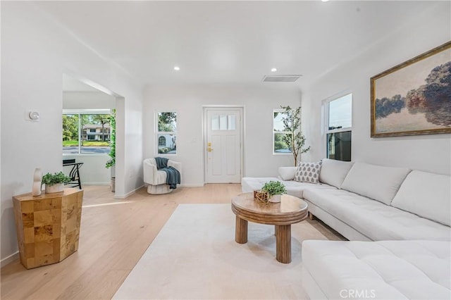 living area featuring visible vents, recessed lighting, baseboards, and light wood-style floors
