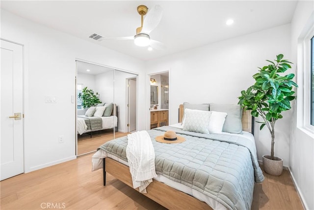 bedroom featuring light wood-type flooring, visible vents, and baseboards