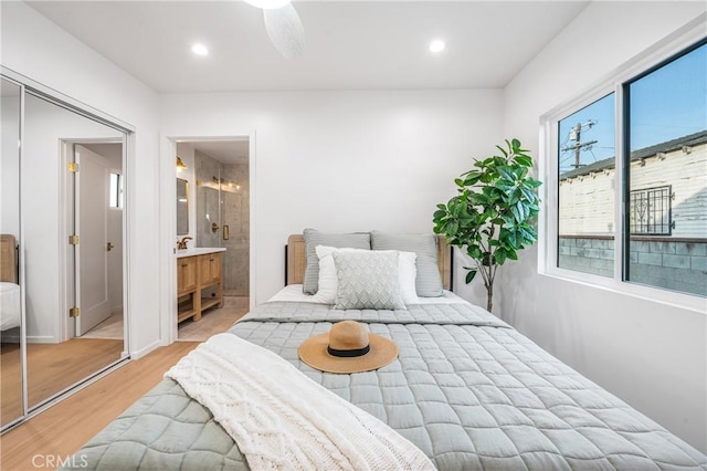 bedroom featuring recessed lighting, light wood-type flooring, and connected bathroom