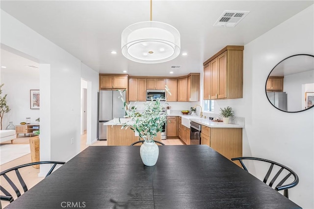 kitchen featuring recessed lighting, a sink, visible vents, light countertops, and appliances with stainless steel finishes