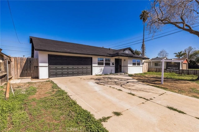 single story home featuring stucco siding, a garage, and fence