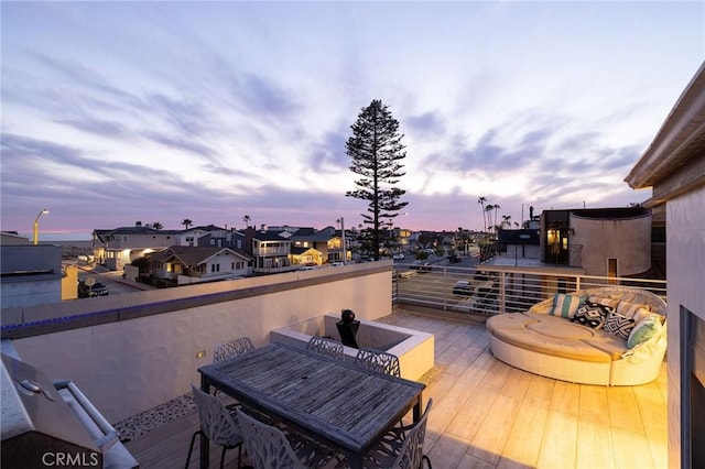 wooden deck featuring a residential view and outdoor dining space