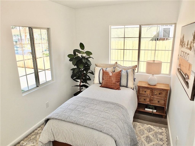 bedroom featuring multiple windows and baseboards