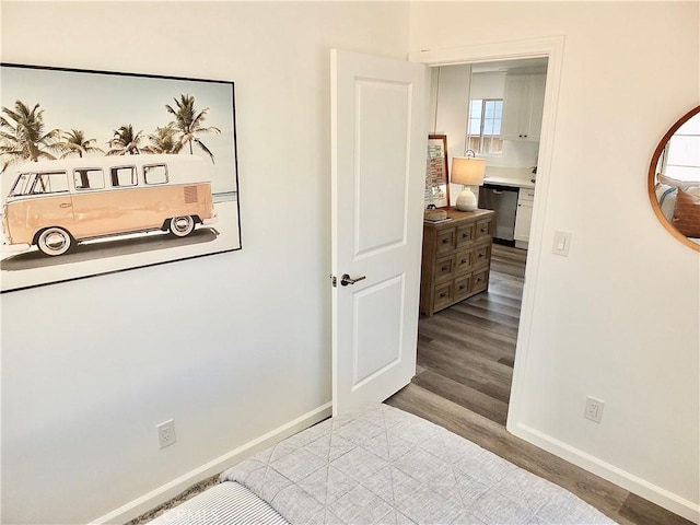 bedroom with baseboards and wood finished floors