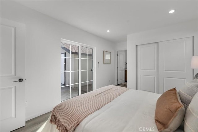 bedroom featuring recessed lighting, a closet, baseboards, and wood finished floors