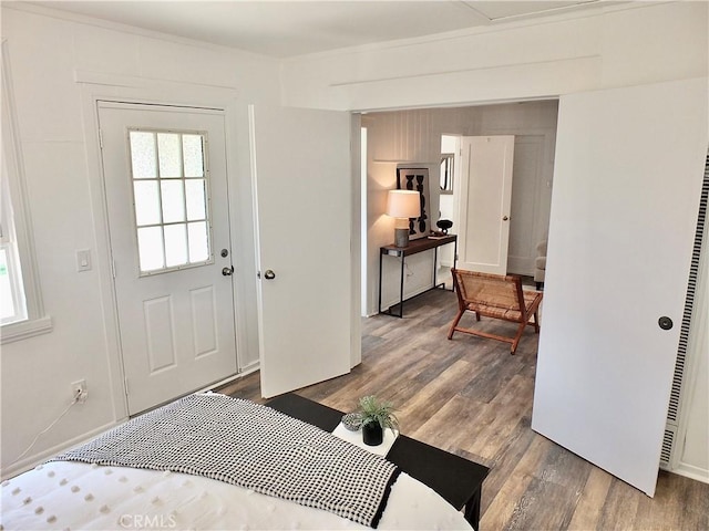 bedroom featuring multiple windows and wood finished floors