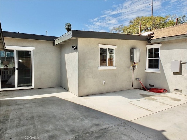 exterior space featuring crawl space, a patio, and stucco siding