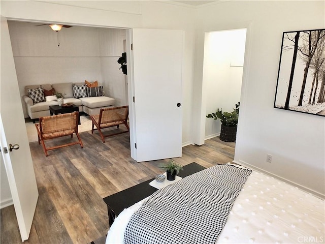 bedroom with baseboards and wood finished floors