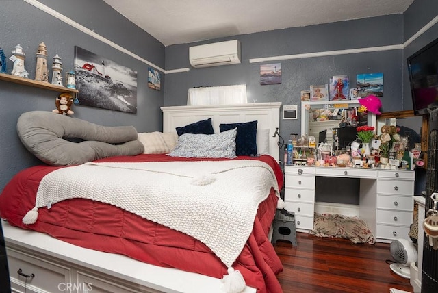 bedroom featuring an AC wall unit, a textured wall, and dark wood-style flooring