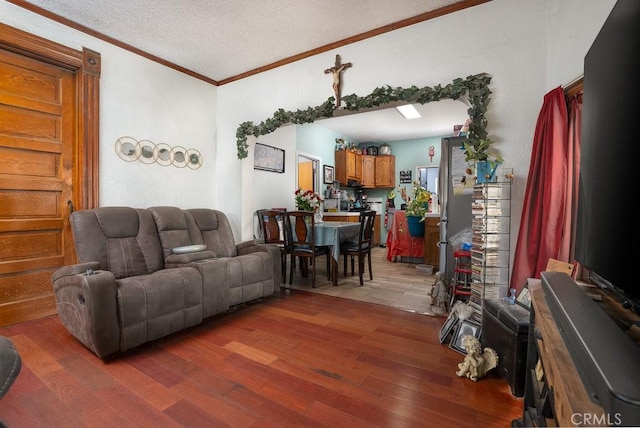 living room with crown molding, a textured ceiling, and wood finished floors