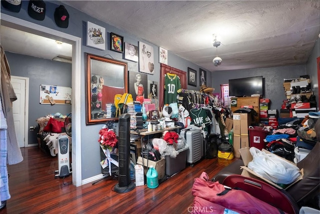 miscellaneous room with baseboards and dark wood-type flooring