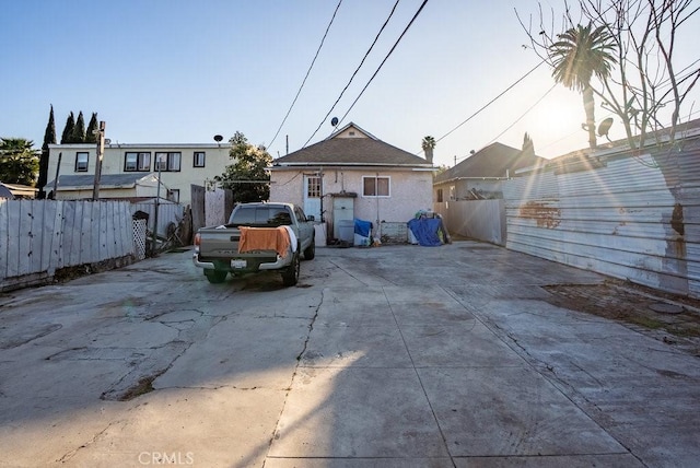 rear view of house featuring fence