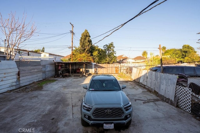 view of parking featuring fence