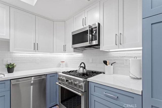 1409 Havenhurst Dr Unit 3, West Hollywood, CA 90046 - kitchen with white cabinetry, light stone countertops, backsplash, and stainless steel appliances
