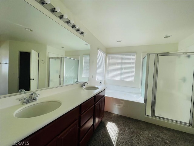 full bathroom with double vanity, a sink, a shower stall, and a bath