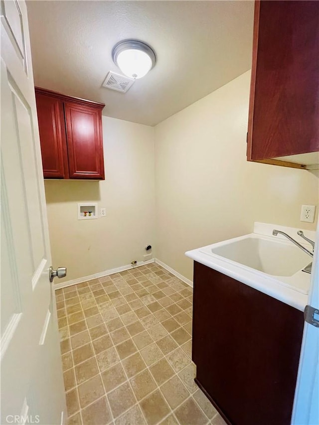 laundry area with cabinet space, baseboards, visible vents, hookup for a washing machine, and a sink