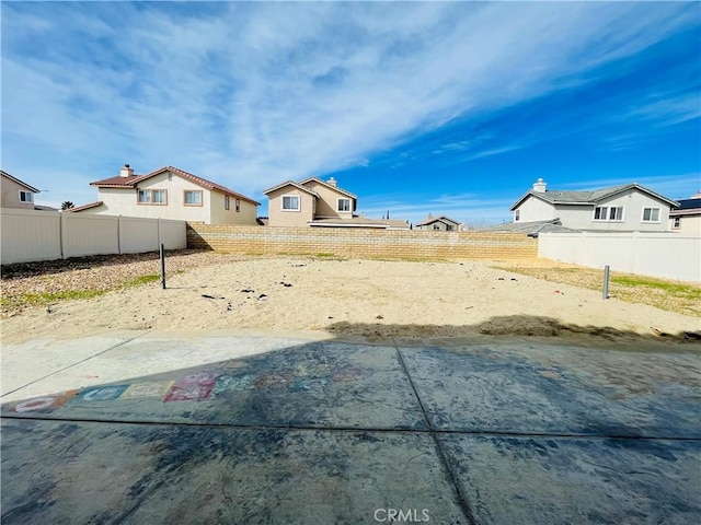 view of yard with a fenced backyard and volleyball court