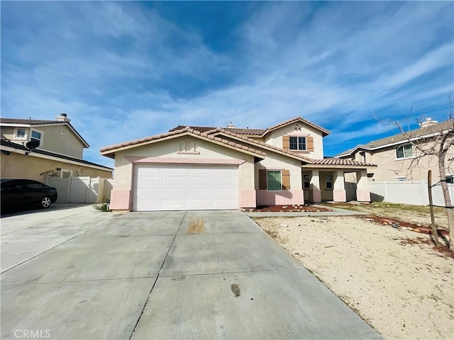 mediterranean / spanish-style house with an attached garage, fence, a tile roof, driveway, and stucco siding