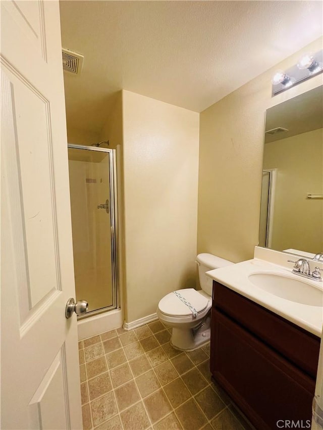 bathroom with visible vents, toilet, tile patterned flooring, vanity, and a shower stall