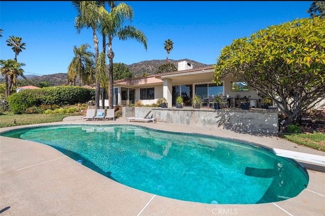 pool featuring a mountain view and a patio