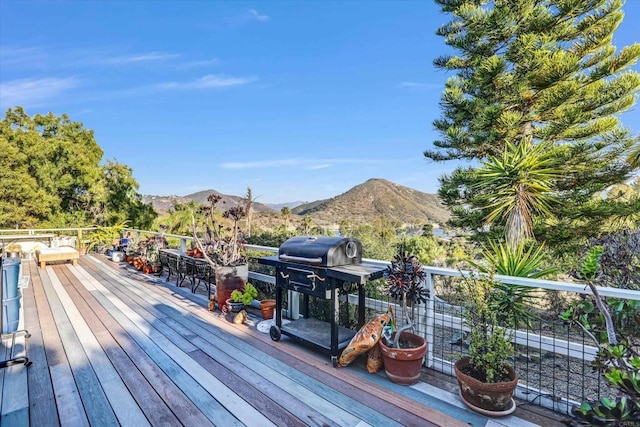 wooden terrace featuring a mountain view and grilling area