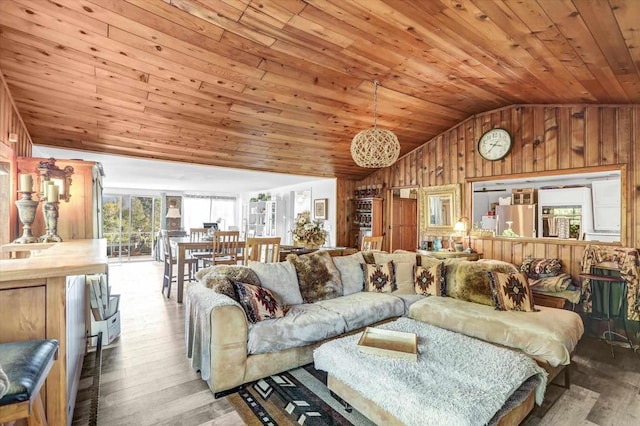 living room featuring lofted ceiling, wood walls, wood finished floors, and wood ceiling