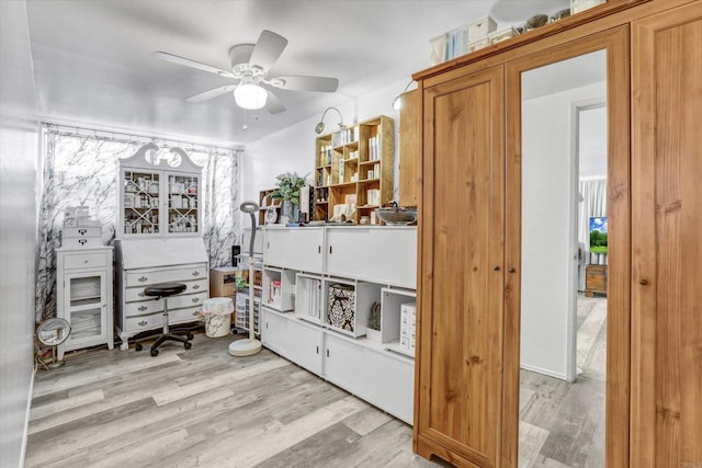 misc room with light wood-type flooring and a ceiling fan