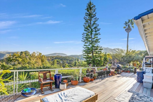 wooden terrace with a grill and a mountain view