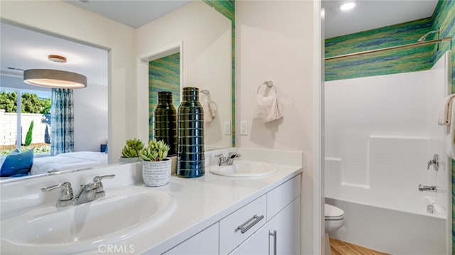 full bathroom with toilet, bathing tub / shower combination, a sink, and ensuite bathroom