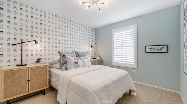 bedroom with a chandelier, light carpet, and baseboards